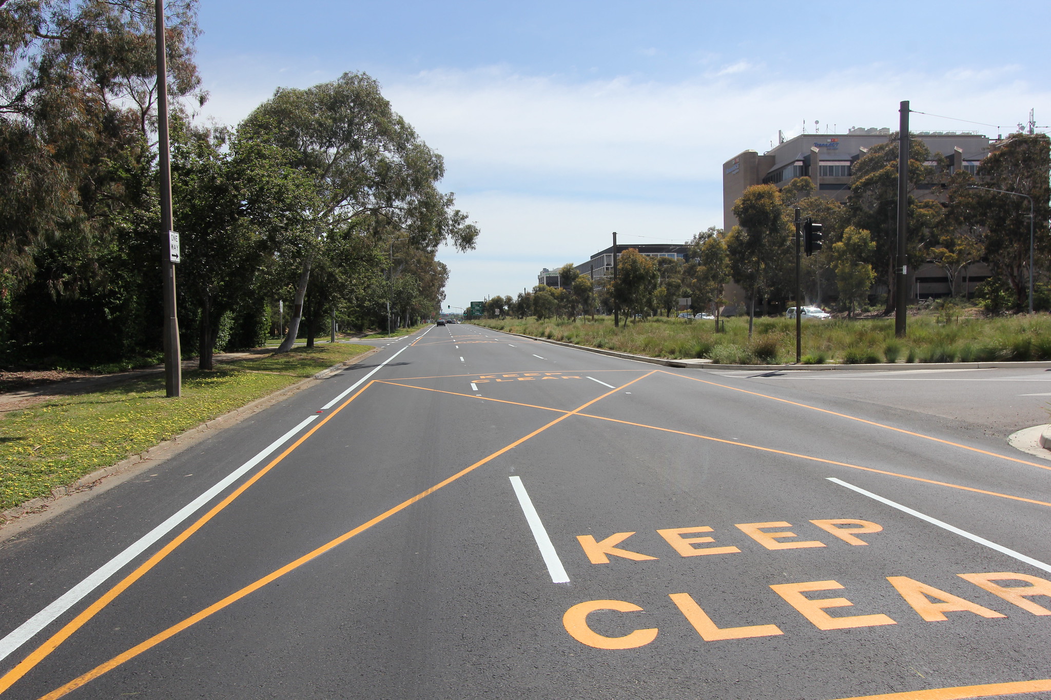 Image of the same section of road as the &lsquo;Before&rsquo; image after the works were completed. Image of 3 lane road with new pavement, new white line marking and new yellow keep clear line marking.