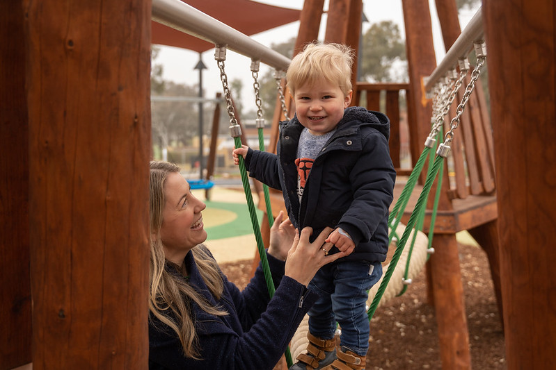 Smiling adult and child in playground