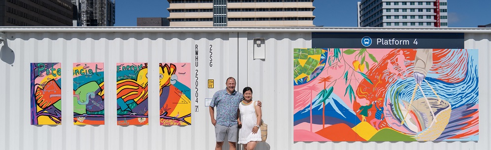 2 artist in front of their work at the Woden bus interchange