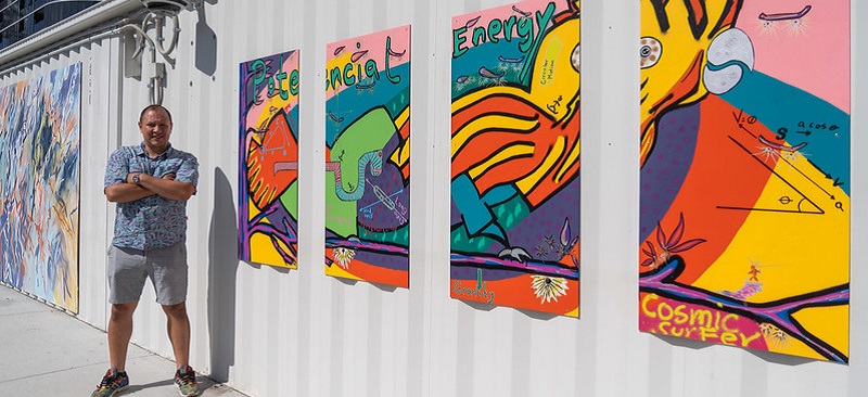 Carlos in front of his artwork - Cosmic Surfer Here